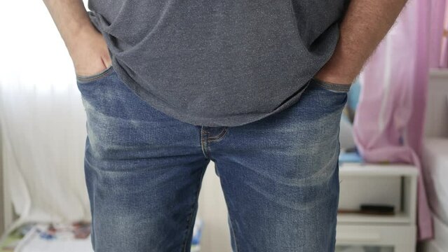 Man Putting His Mobile Phone in His Pants Pocket. Disappointed Person Keeping His Hands in His Pockets. Financial Crisis Poverty  Debts Loans and Bankruptcy Concept. 