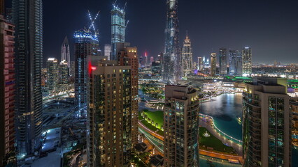 Fototapeta na wymiar Dubai Downtown cityscape with tallest skyscrapers aerial night timelapse.