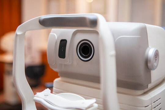 Close-up of an optical instrument for measuring eyesight inside a doctor's office. Equipment for eye exams. Optician's equipment for vision test and analysis.