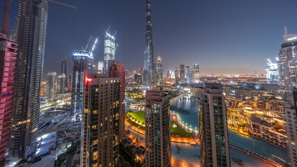 Fototapeta na wymiar Dubai Downtown cityscape with tallest skyscrapers around aerial night to day timelapse.