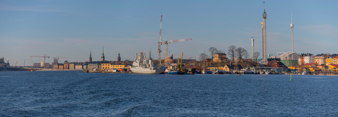 Panorama view over the shipyard Beckholmen, amusement park towers and the skyline of the old town Gamla Stan a sunny winter day in Stockholm