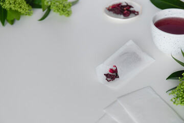 Tea bags with dry leaves hibiscus on white background