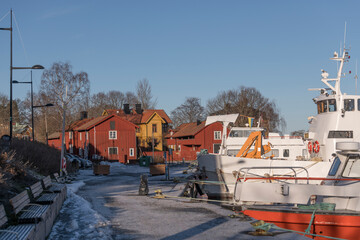 Harbor view with commuting boats in the district town of Vaxholm a sunny winter day in the...