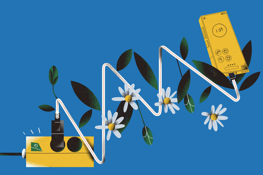 Spring arrives at technology. A smartphone cable plugged both into the power output and the smartphone flourish like a plant full of flowers. Digital domain and seasonal concepts.