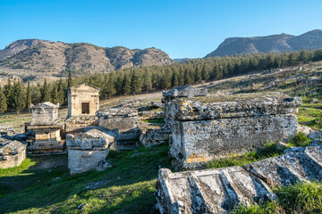 Fototapeta na wymiar The necropolis of Hierapolis is filled with sarcophagi, rock tombs, was an ancient Greek city located on hot springs in classical Phrygia in Anatolia and currently comprise an archaeological museum.