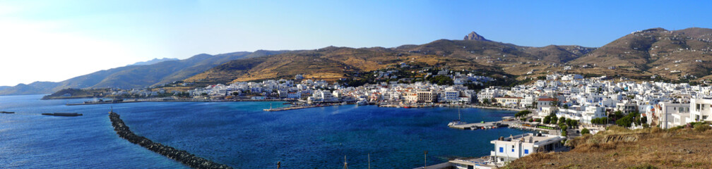 Naklejka na ściany i meble Superb panoramic view of the port of Tinos, a magnificent Cycladic island in the heart of the Aegean Sea, dominated by the Church of Panaghia Evangelistria