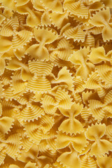 Uncooked farfalle pasta background,top view and close up