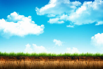 Cross section brown soil and green grass in under ground with blue sky in background - 482904399