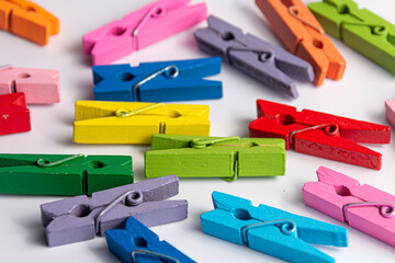 Small, colorful clothespins. On a white background.