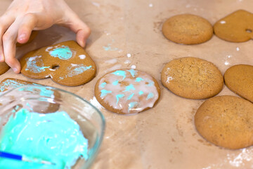 decoration of ginger cookies on a wooden table. sprinkle on cookies. cooking.