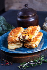 Homemade russian pancakes with meat closeup. Closeup restaurant serving of traditional maslenitsa meal.