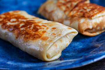 Homemade russian pancakes with meat closeup. Closeup restaurant serving of traditional maslenitsa meal.
