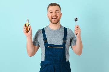 Portrait of smiling worker in blue uniform isolated on blue background