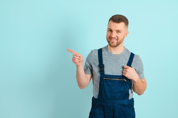 Close-up portrait of his he nice attractive cheerful cheery content guy repairer craftsman isolated over blue color background. - obrazy, fototapety, plakaty