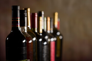 Wine bottles collection on a dark background with copy space