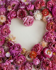 Valentine's Day card. Heart of dry buds of peony roses and helichrysum flowers in shades of pink