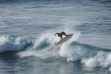 Surfer makes an aerial maneuver in a perfect wave