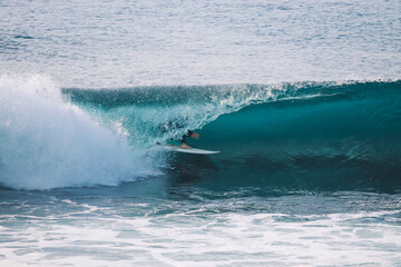 Surfer in a perfect barrel wave