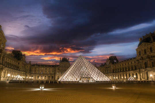 The famous Parisian Louvre Palace and its iconic glass pyramide in the early morning