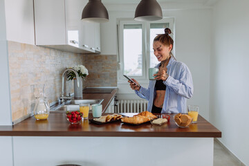 Woman using smartphone at home in the lounge