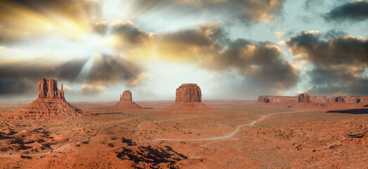 Sunset sky with streaks of yellow color over Monument Valley, a region of the Colorado Plateau...