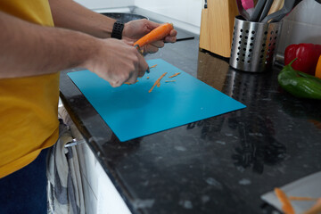 Anonymous person peeling a carrot