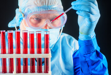 Doctor works with blood sample. Laboratory analysis. Blood research. Scientist make blood test.