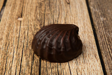 Marshmallows in chocolate on a wooden background.The dessert is delicious.