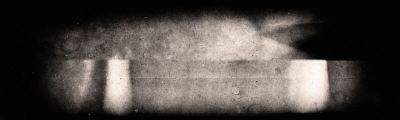 Scratched and damaged grainy backing of old photographic film.