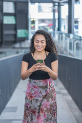 Young woman in the city calling by phone.