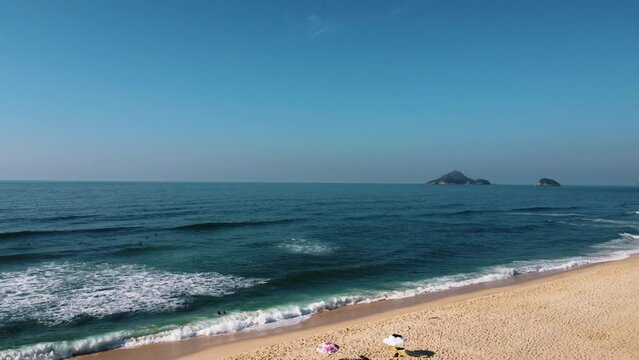 Aerial view of Macumba Beach, a paradise in the west side of Rio de Janeiro, Brazil. Big hills around. Sunny day at dawn. Drone take.
