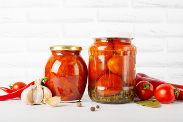 red canned, canned tomatoes in a glass jar