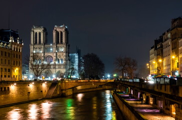 Fototapeta premium Night Paris, Not-ter-Dame de Paris illuminated by lights, cityscape