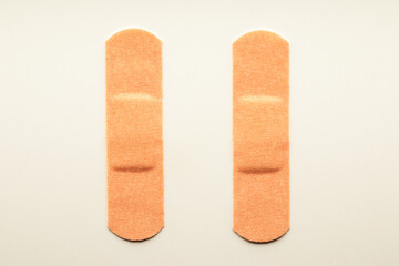 Two stripes of beige disposable medical adhesive plaster