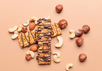 Tasty chocolate nut bars on color background