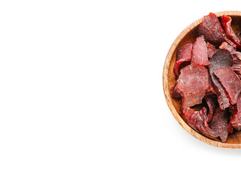 Plate with spicy beef jerky on white background