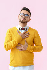 Dreamy man with stylish manicure on color background