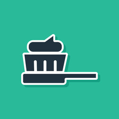 Blue Toothbrush with toothpaste icon isolated on green background. Vector Illustration