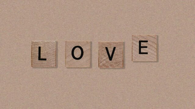 Natural wood texture cubes on love text on Noise paper texture background, valentine card concept. Word of love are made of letters from wood for Valentines Day greeting card.4 in 1 animation footage 