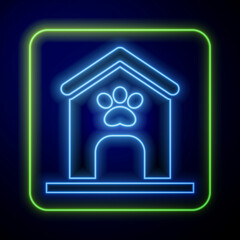 Glowing neon Dog house and paw print pet icon isolated on blue background. Dog kennel. Vector