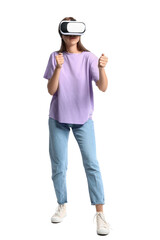 Young woman in lilac t-shirt with VR glasses on white background
