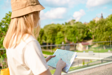 Beautiful woman checking a city map. Vacation trip, lifestyle holiday concept