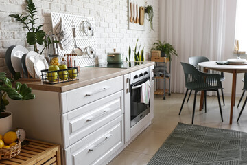 Fruit basket with apples on table in kitchen interior