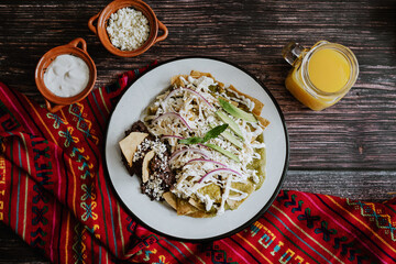 Mexican green chilaquiles with chicken and spicy green sauce traditional breakfast in Mexico	