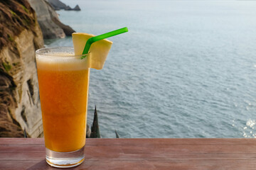 Glass of fresh cocktail on table at sea resort