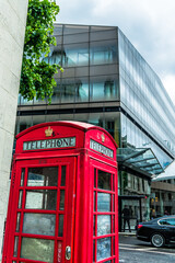 Red Telephone booth in London with reflection of St Paul's Cathedral in the backround