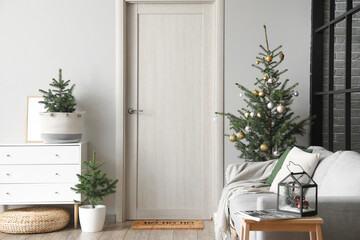 Interior of light living room with decorated Christmas trees