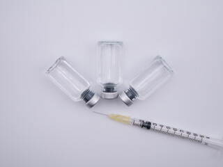Top view of containers with liquid medicine and syringe isolated on white background - 482928783