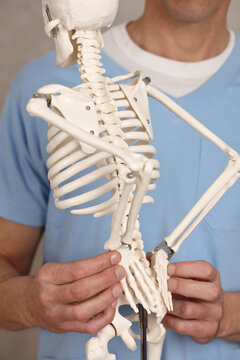 Low Back pain concept. Doctor Chiropractor explains causes of back pain to Patient