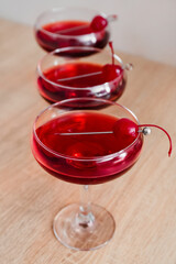 Glasses of tasty Manhattan cocktail on wooden table, closeup